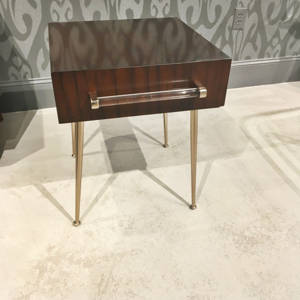 A subtle hint of acrylic is used for the hardware on this funky end table.
