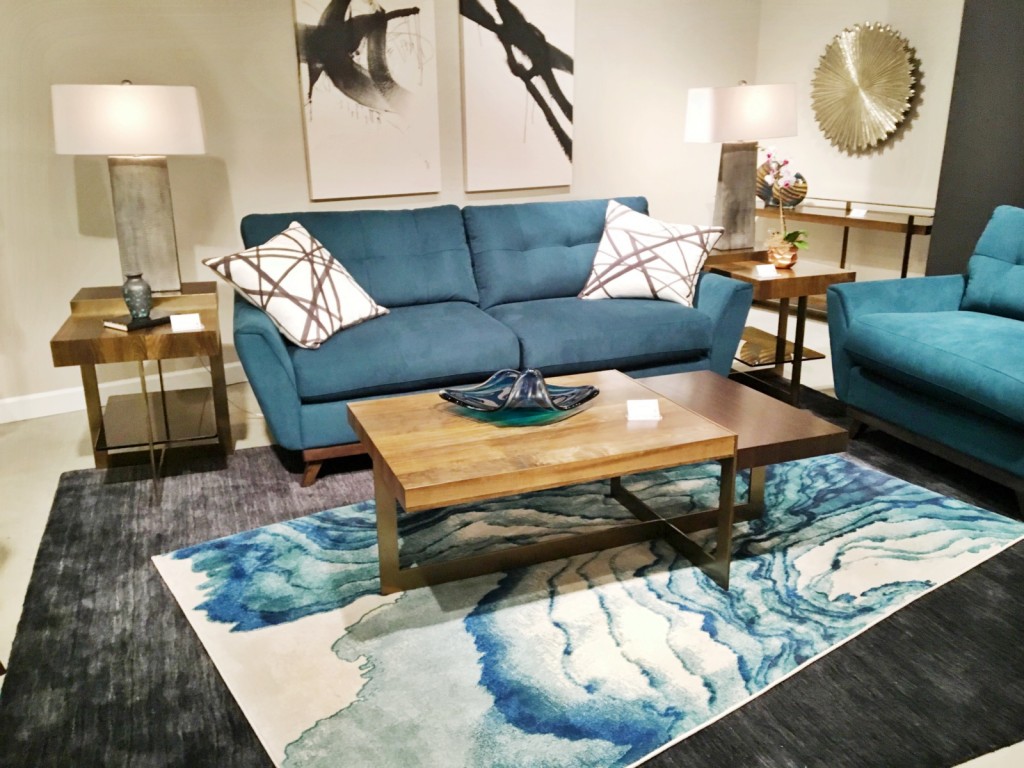 A beautifully blue vignette found at Hammary. Plus the tables feature a fumed wood in two species with a polished brass base. Now that's a room that packs a punch!