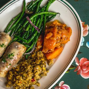 A classic southern comfort dish - SAUSAGE STUFFED CHICKEN BREAST Served with candied yams, cornbread dressing and green beans