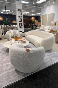 a white boucle rounded sofa and chairs